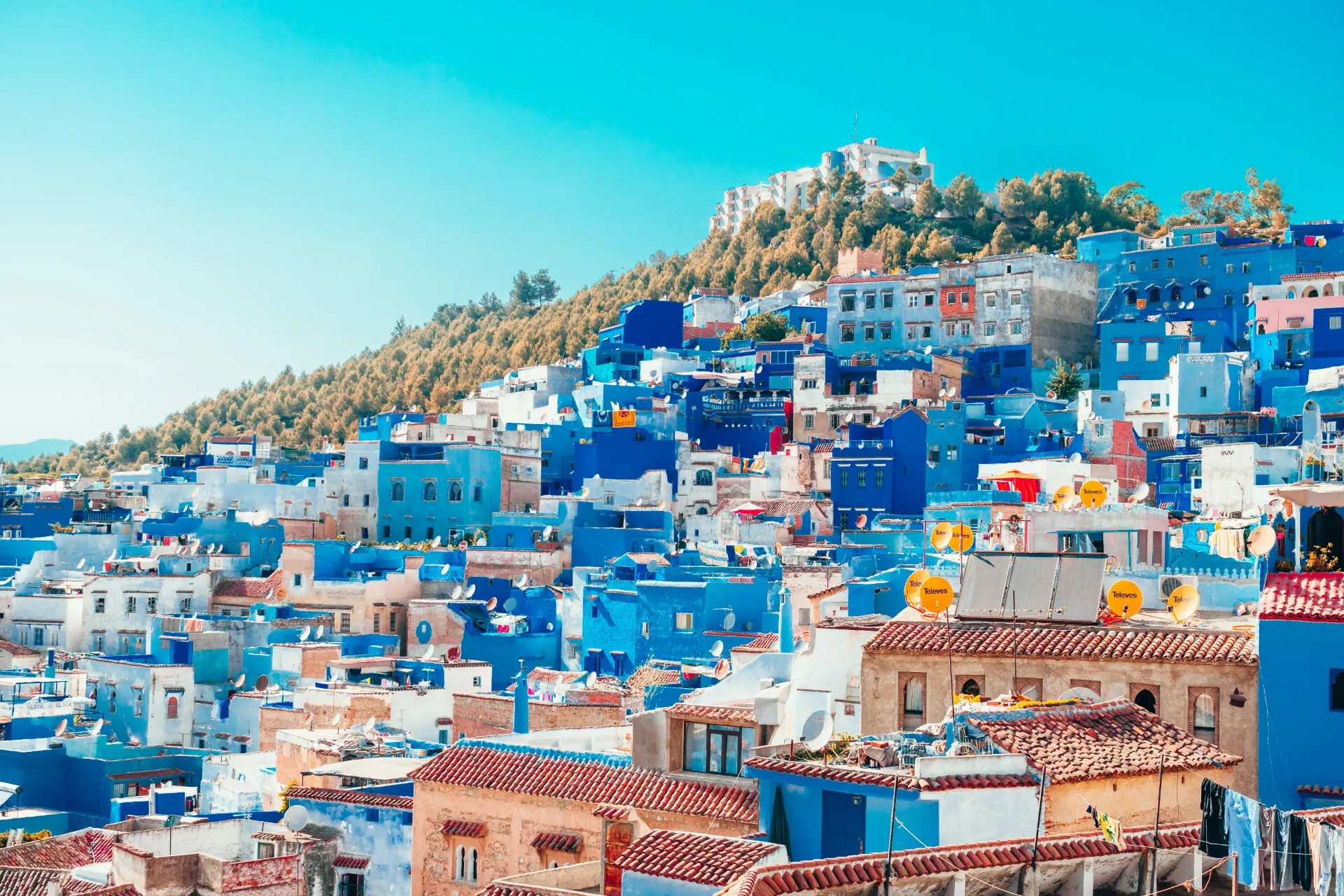 blue and white painted houses on the cliff, morocco