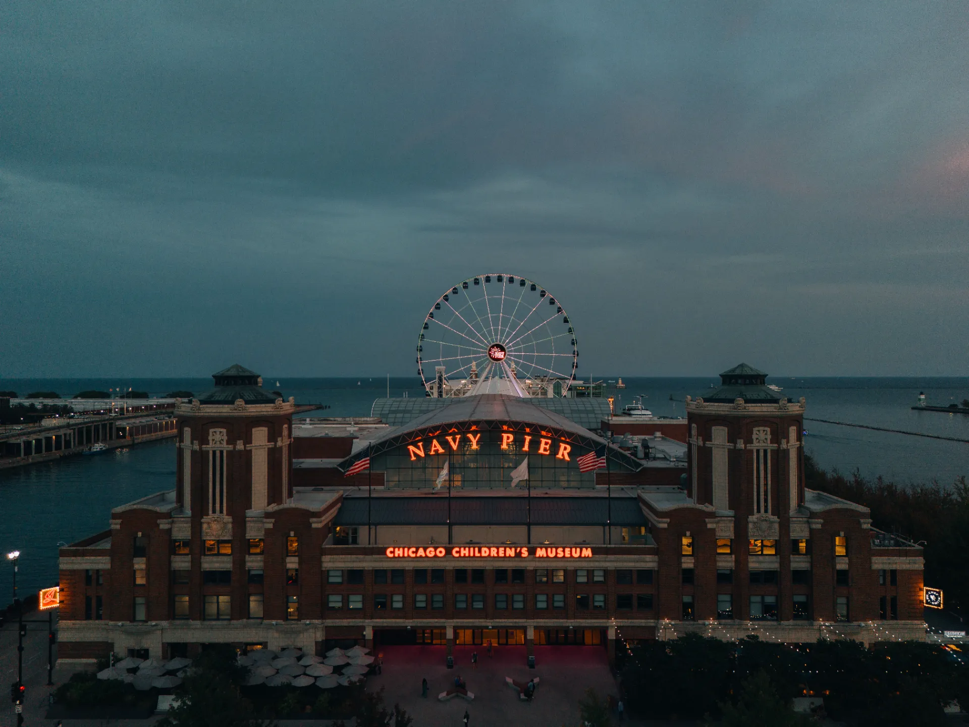 Aerial view of Chicago's Navy Pier at twilight, featuring the iconic Ferris wheel and lakefront.